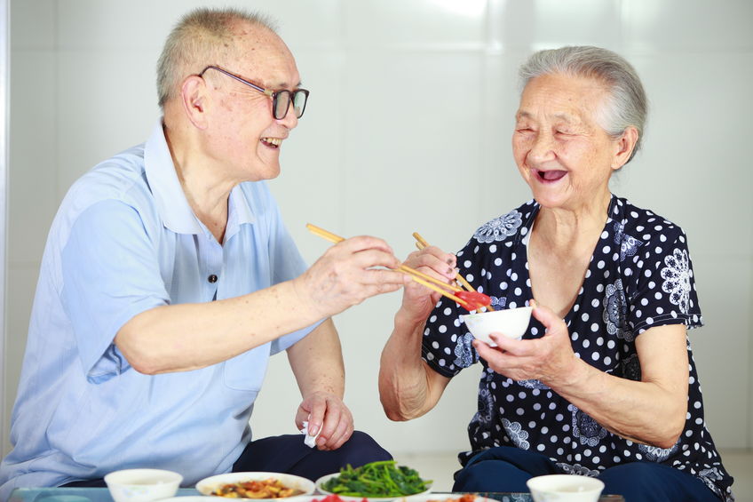 senior asian couple having meal indoor